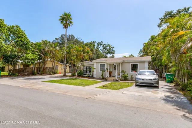a view of a house with a backyard and windows