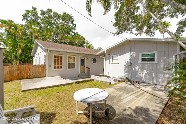 a bedroom with a bed and a lamp on dresser