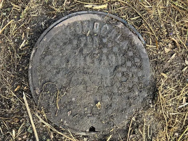 a front view of multi story residential apartment building with yard and sign board