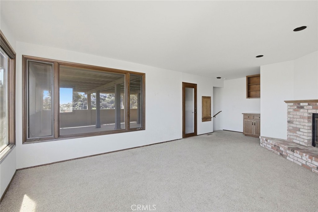 3320 Hill San Diego Ca San Diego, CA 92106 - Photo 14 of 39 a view of empty room with floor to ceiling window and fireplace