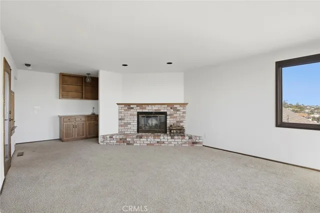an empty room with a fireplace
