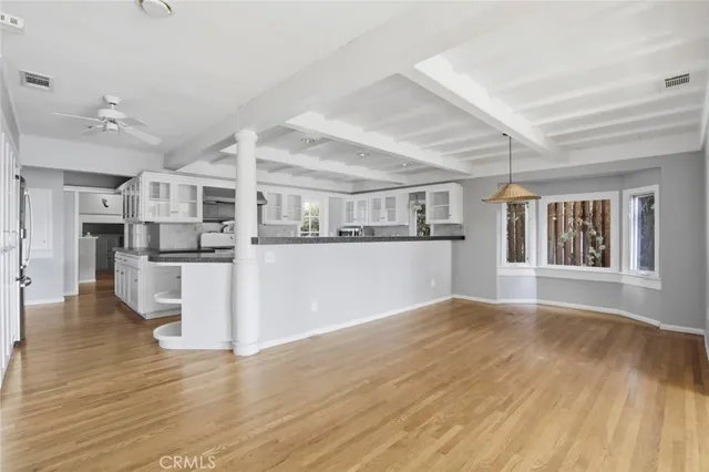 a view of kitchen with wooden floor and electronic appliances