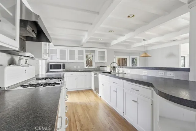 a kitchen with stainless steel appliances granite countertop a sink and cabinets