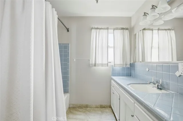 a bathroom with a double vanity sink and a bathtub