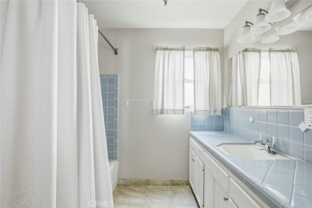 3320 Hill San Diego Ca San Diego, CA 92106 - Photo 29 of 39 a bathroom with a double vanity sink and a bathtub