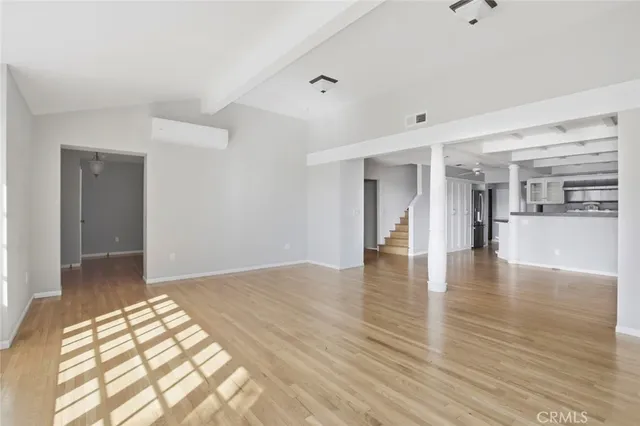 a view of an empty room and wooden floor