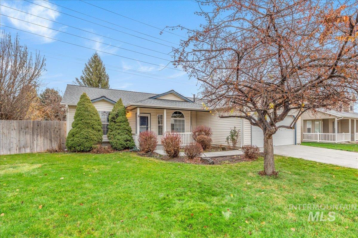 Ranch-style home with a porch, concrete driveway, an attached garage, and a shingled roof