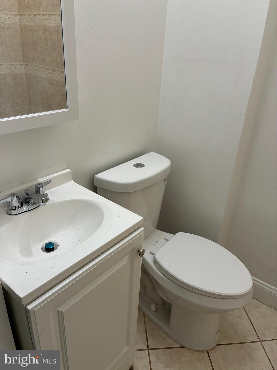 1410 West Porter Street Philadelphia, PA 19145 - Photo 14 of 17 a white toilet sitting next to a bathroom sink