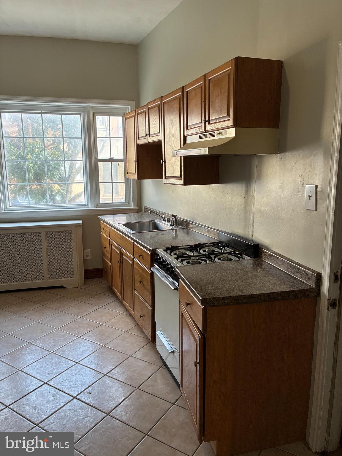 1410 West Porter Street Philadelphia, PA 19145 - Photo 2 of 17 a kitchen with stainless steel appliances granite countertop a stove and a sink