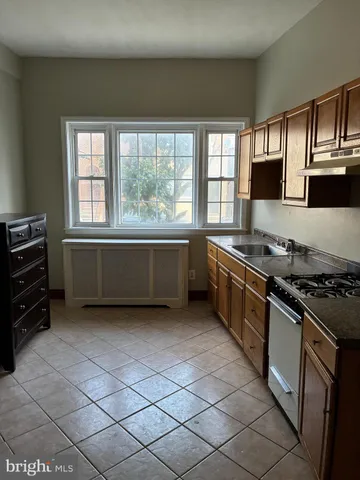 a kitchen with stainless steel appliances granite countertop a stove and a sink