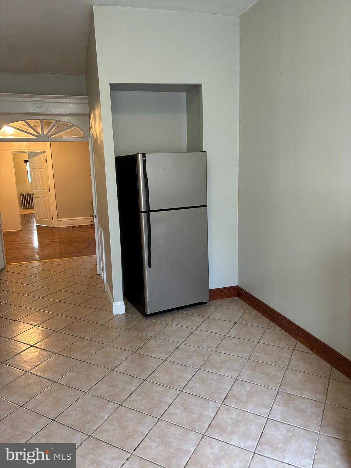 1410 West Porter Street Philadelphia, PA 19145 - Photo 5 of 17 a view of a refrigerator in kitchen and an empty room