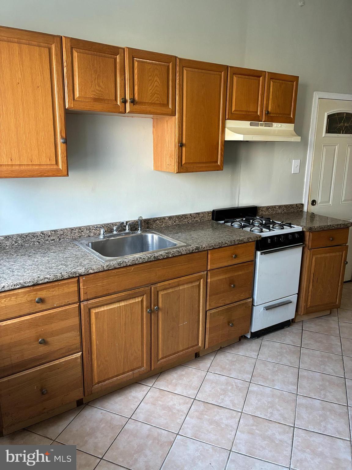 1410 West Porter Street Philadelphia, PA 19145 - Photo 6 of 17 a kitchen with stainless steel appliances granite countertop a stove a sink and a white cabinets