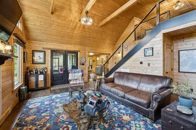 a living room with furniture a fireplace and a large window