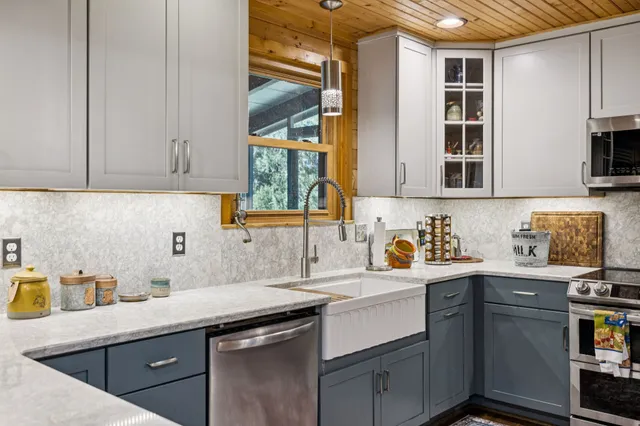 a bathroom with a shower sink and a mirror