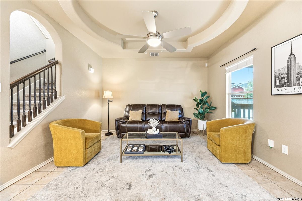 3831 Bacall Way Converse, TX 78109 - Photo 13 of 33 a living room with a couch and a chandelier