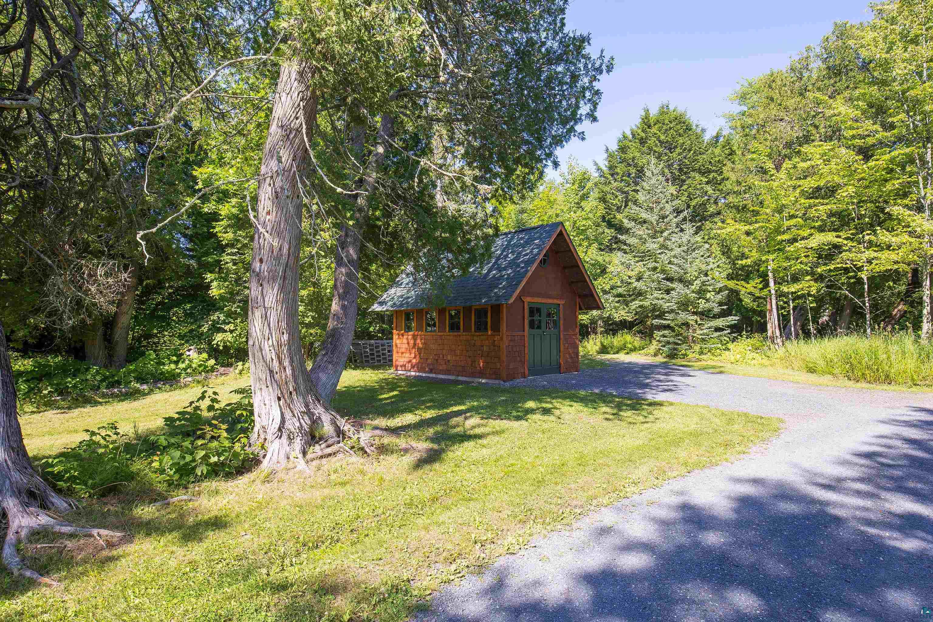 89405 Jack Pine Road Cornucopia, WI 54827 - Photo 23 of 60 View of outbuilding with driveway and a wooded view