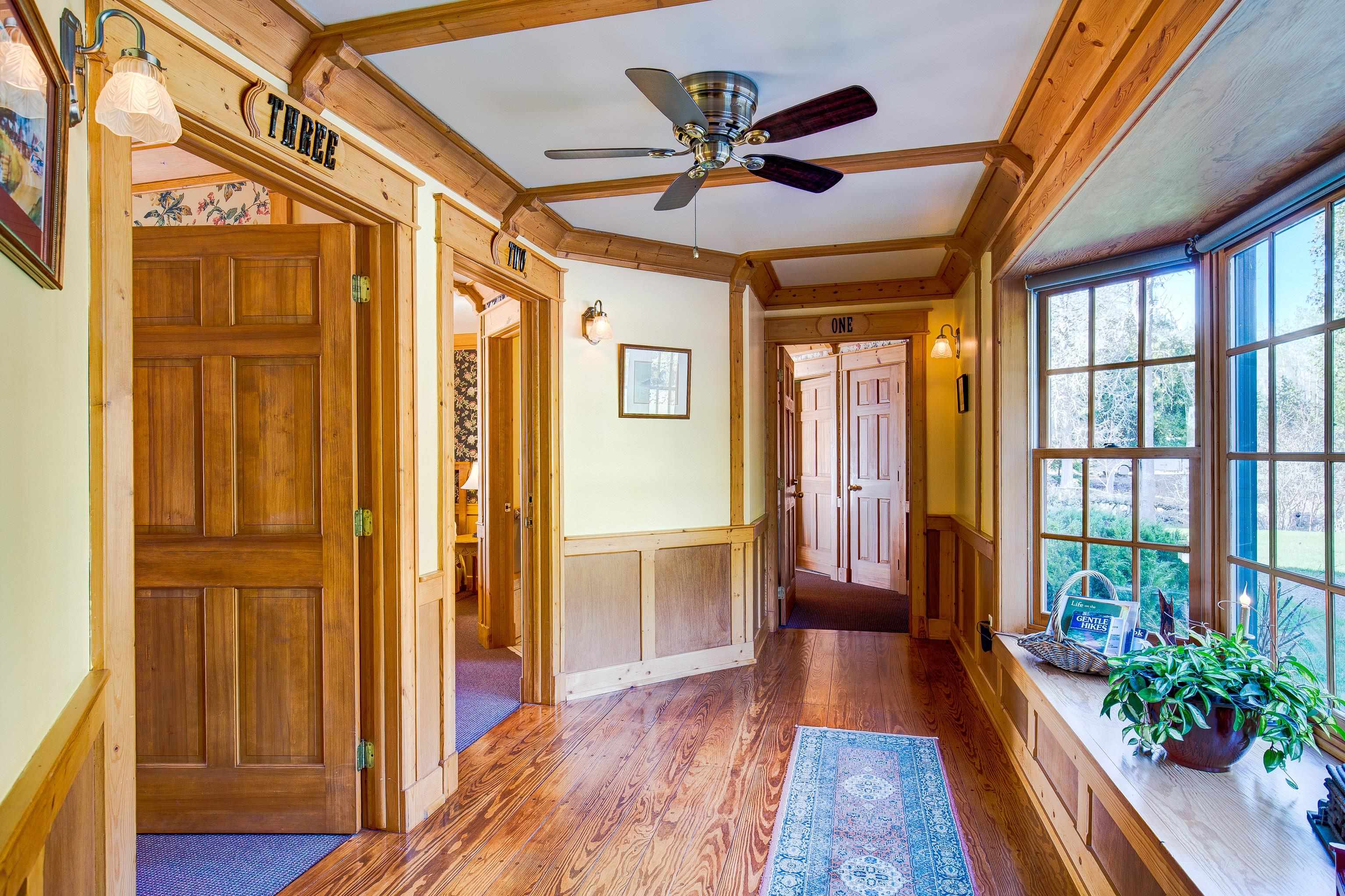 89405 Jack Pine Road Cornucopia, WI 54827 - Photo 39 of 60 Foyer entrance with hardwood / wood-style floors, a wainscoted wall, and a ceiling fan
