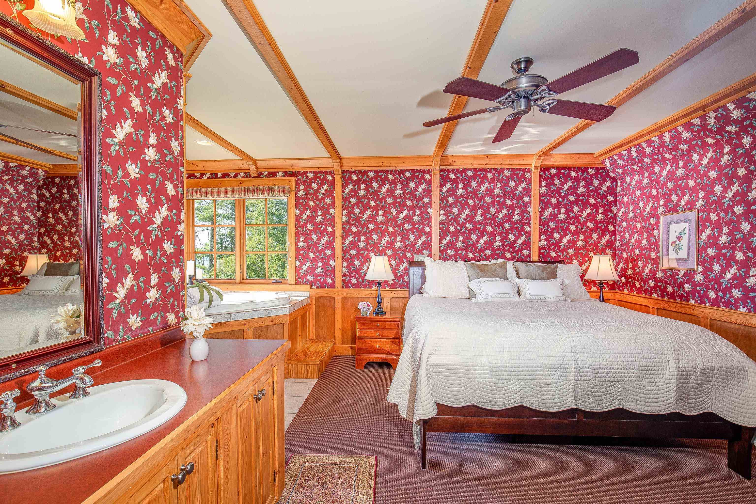 89405 Jack Pine Road Cornucopia, WI 54827 - Photo 42 of 60 Bedroom featuring wallpapered walls, a wainscoted wall, carpet flooring, and crown molding