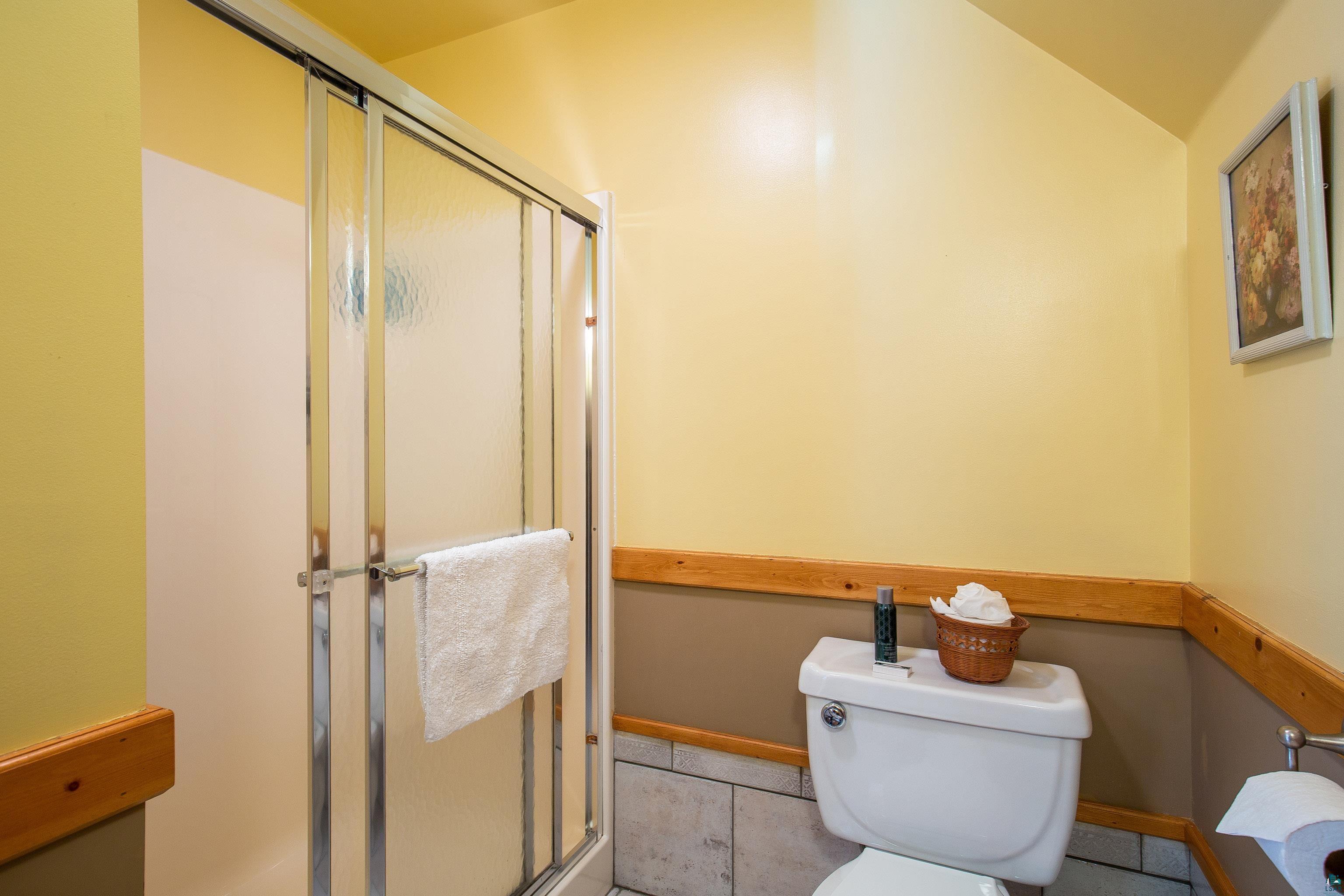 89405 Jack Pine Road Cornucopia, WI 54827 - Photo 44 of 60 Full bathroom with a stall shower and tile patterned flooring