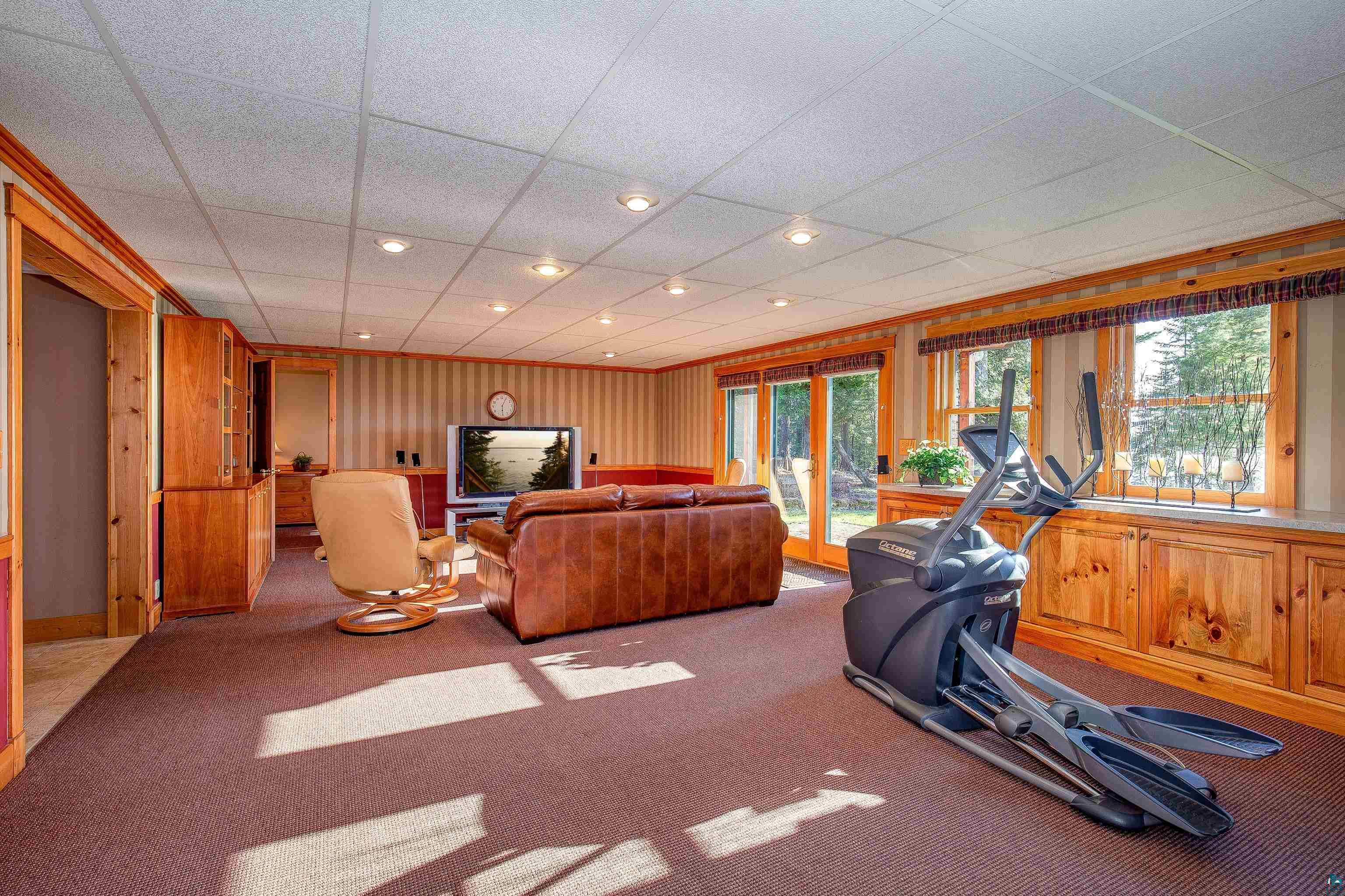 89405 Jack Pine Road Cornucopia, WI 54827 - Photo 50 of 60 Workout room featuring a drop ceiling, plenty of natural light, and carpet