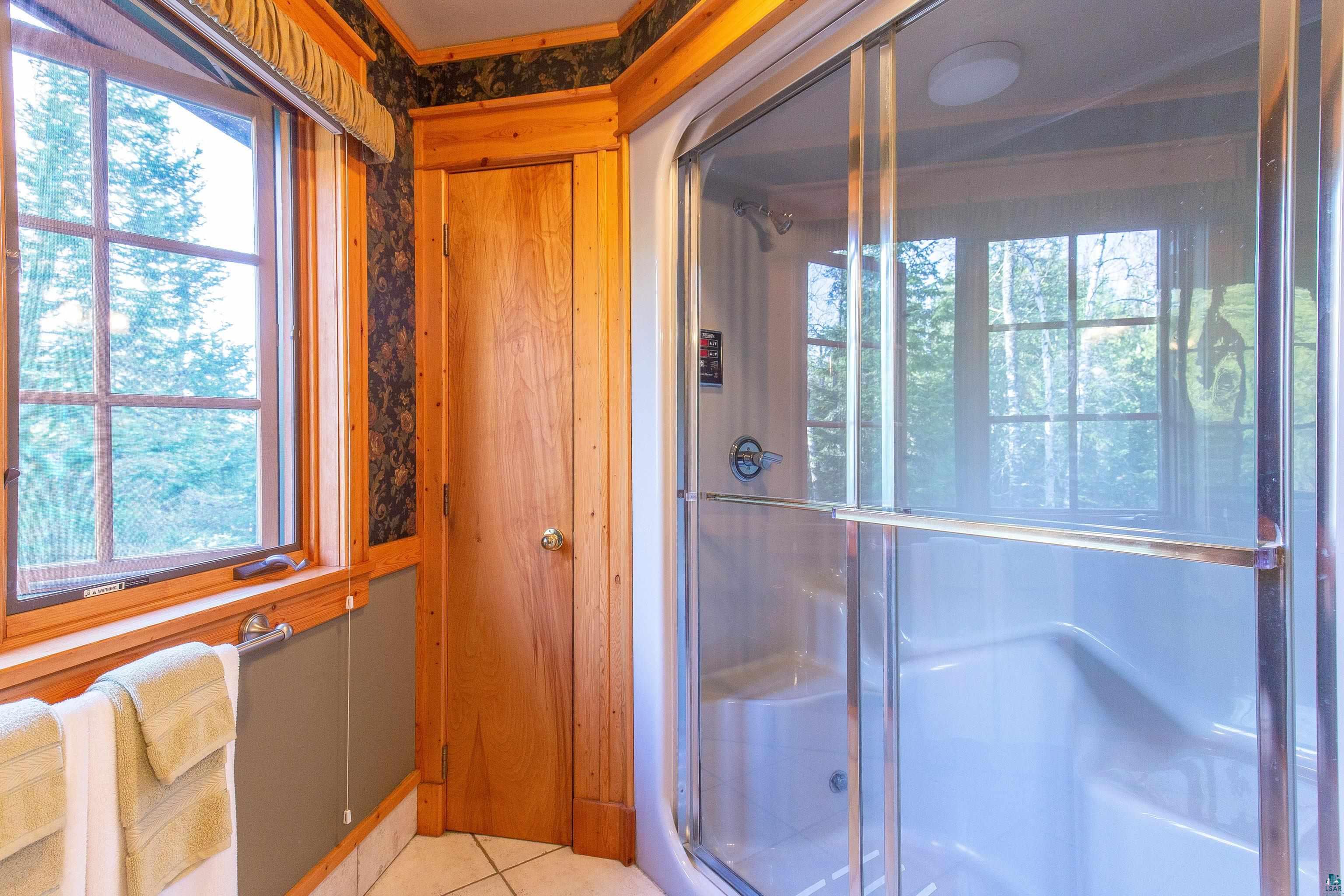 89405 Jack Pine Road Cornucopia, WI 54827 - Photo 56 of 60 Bathroom featuring a shower stall and tile patterned floors