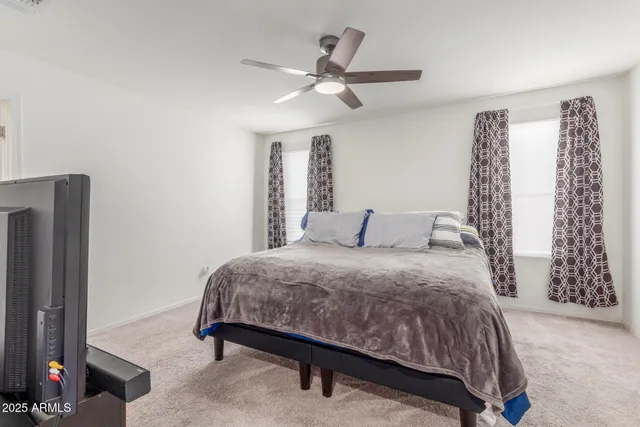 a bedroom with a bed and a chandelier