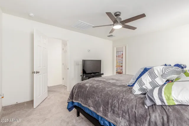 a bed room with a bed and a chair