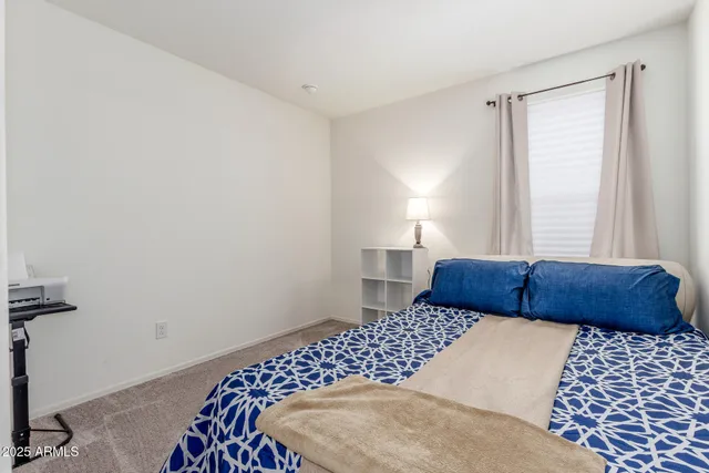 a bedroom with a large bed and a lamp