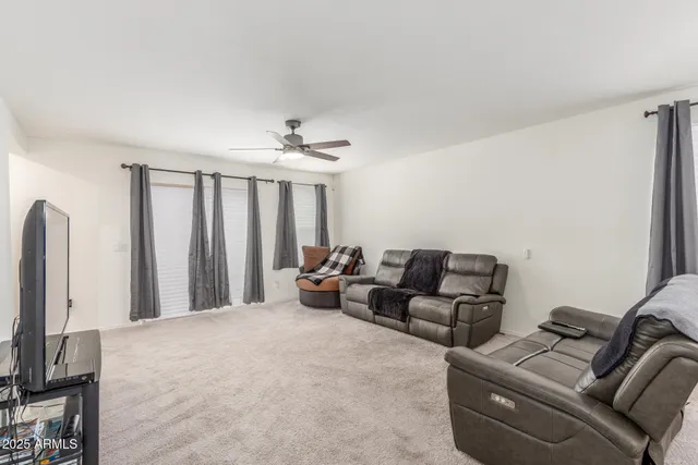 a bed room with furniture and a flat screen tv