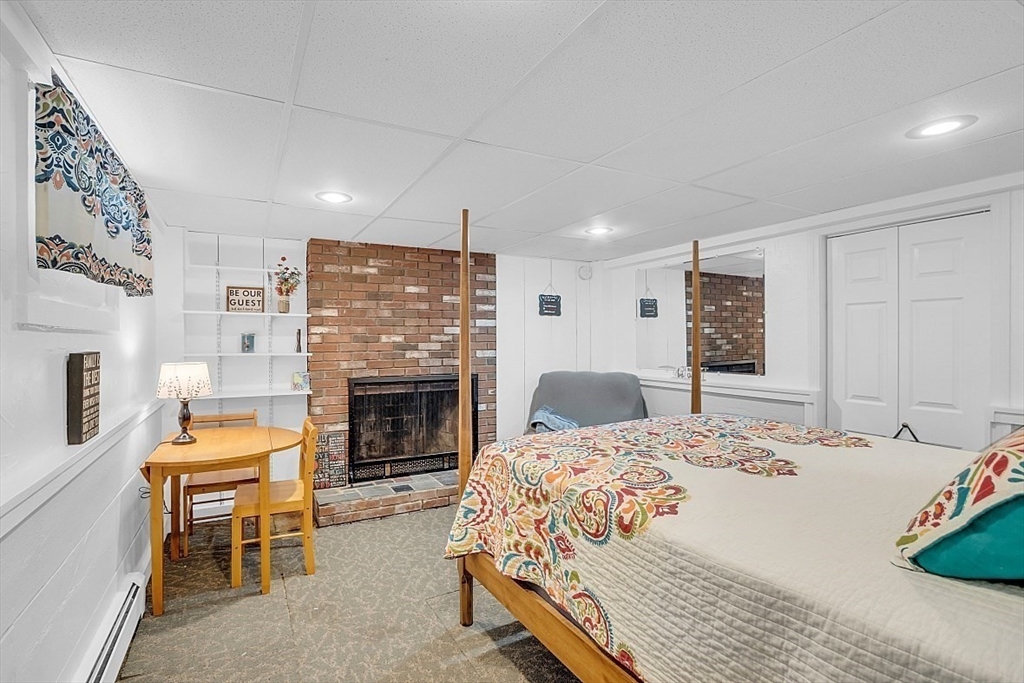 23 Birchwood Road Rutland, MA 01543 - Photo 27 of 35 a bedroom with a bed and a fireplace