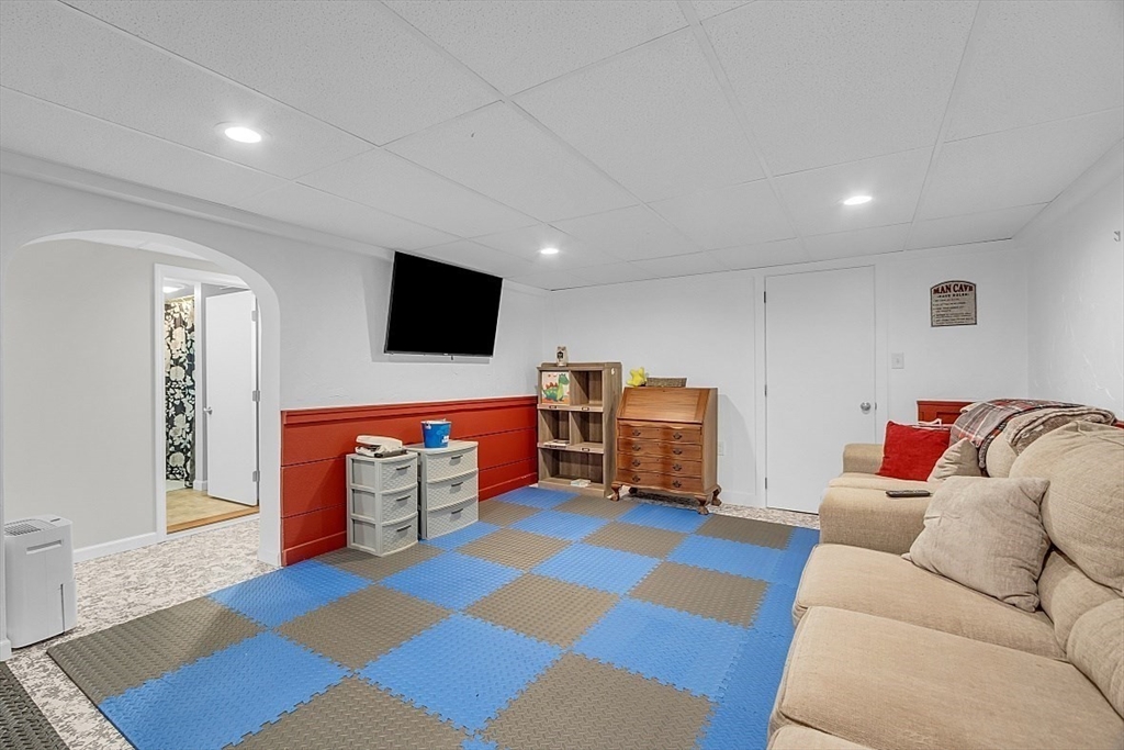 23 Birchwood Road Rutland, MA 01543 - Photo 29 of 35 a living room with furniture and a flat screen tv