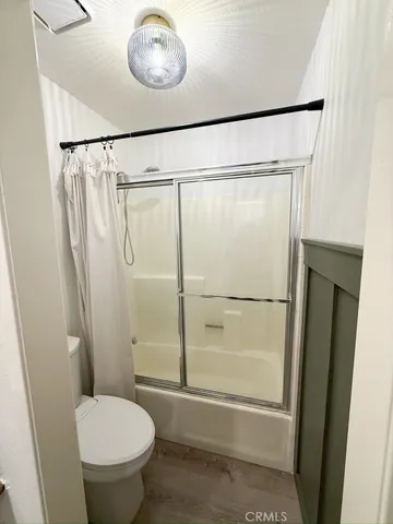 a bathroom with a toilet and a shower