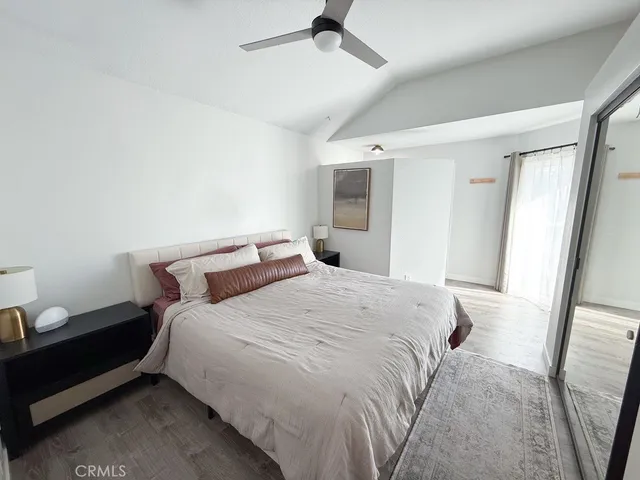 a bedroom with a bed and a mirror