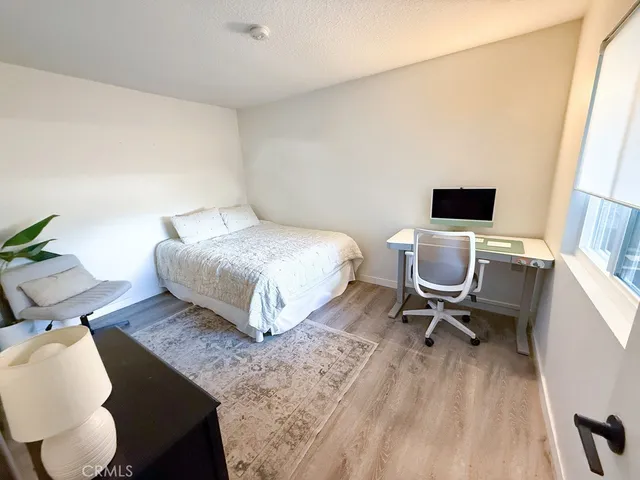 a bedroom with a bed and a chair