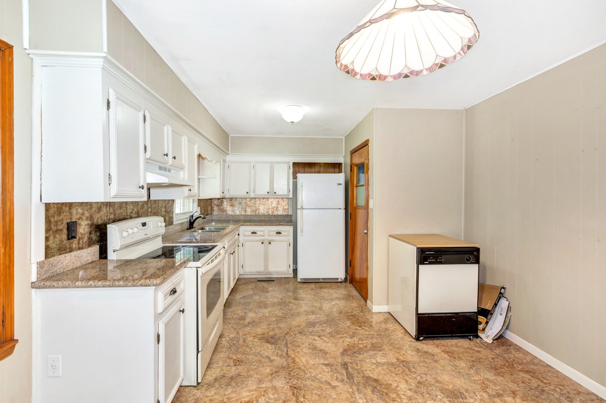 1758 Old Stage Road Ardmore, TN 38449 - Photo 12 of 25 a kitchen that has a lot of cabinets in it and appliances