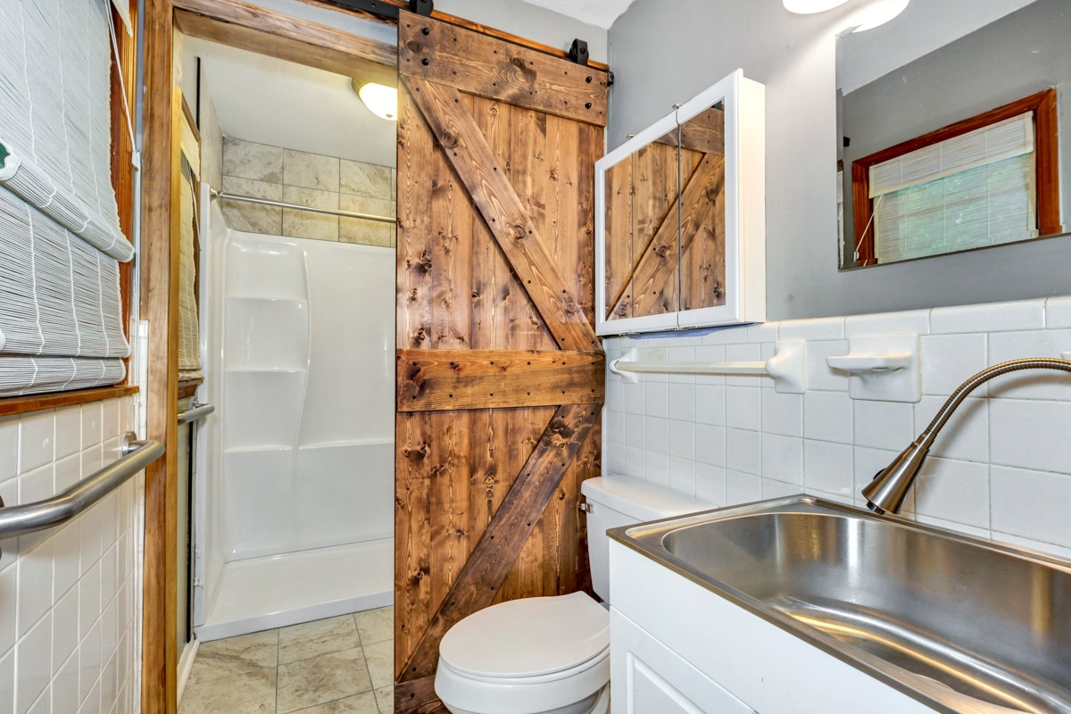 1758 Old Stage Road Ardmore, TN 38449 - Photo 17 of 25 a bathroom with a sink a toilet and shower