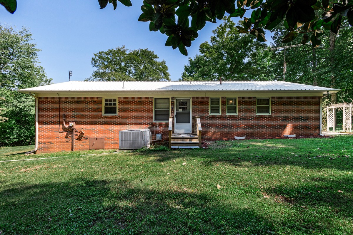 1758 Old Stage Road Ardmore, TN 38449 - Photo 3 of 25 a view of a house with backyard sitting area and garden