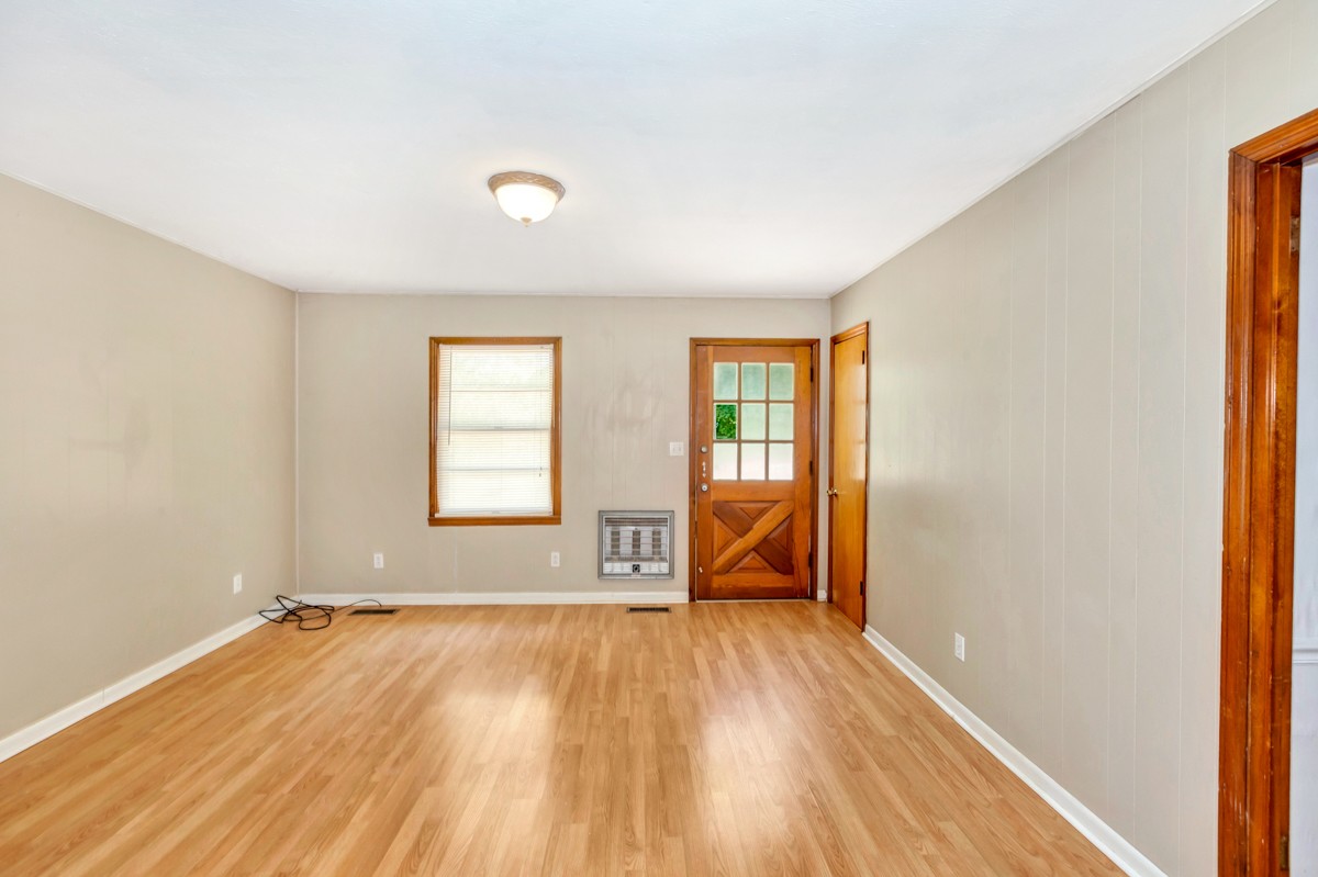 1758 Old Stage Road Ardmore, TN 38449 - Photo 10 of 25 an empty room with wooden floor and windows
