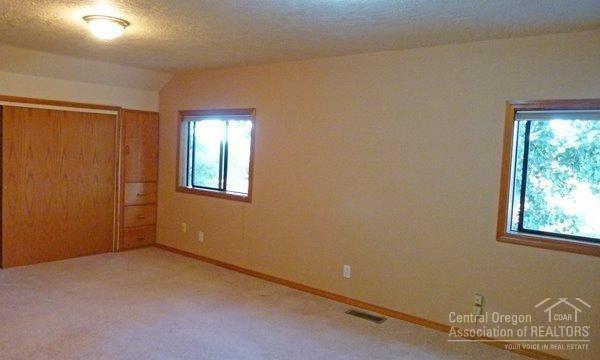 13220 Southwest Houston Lake Road Powell Butte, OR 97753 - Photo 20 of 24 Large bedroom upstairs
