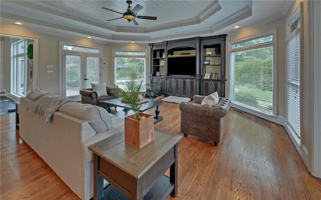 a bathroom with a granite countertop toilet a sink a mirror and a window