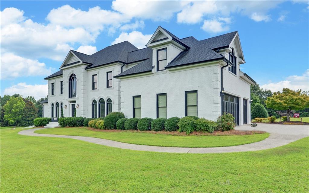 2760 Camp Branch Road Buford, GA 30519 - Photo 2 of 73 a front view of house with yard and green space