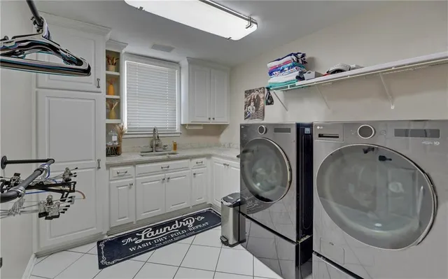 a bathroom with a double vanity sink a mirror and a bathtub