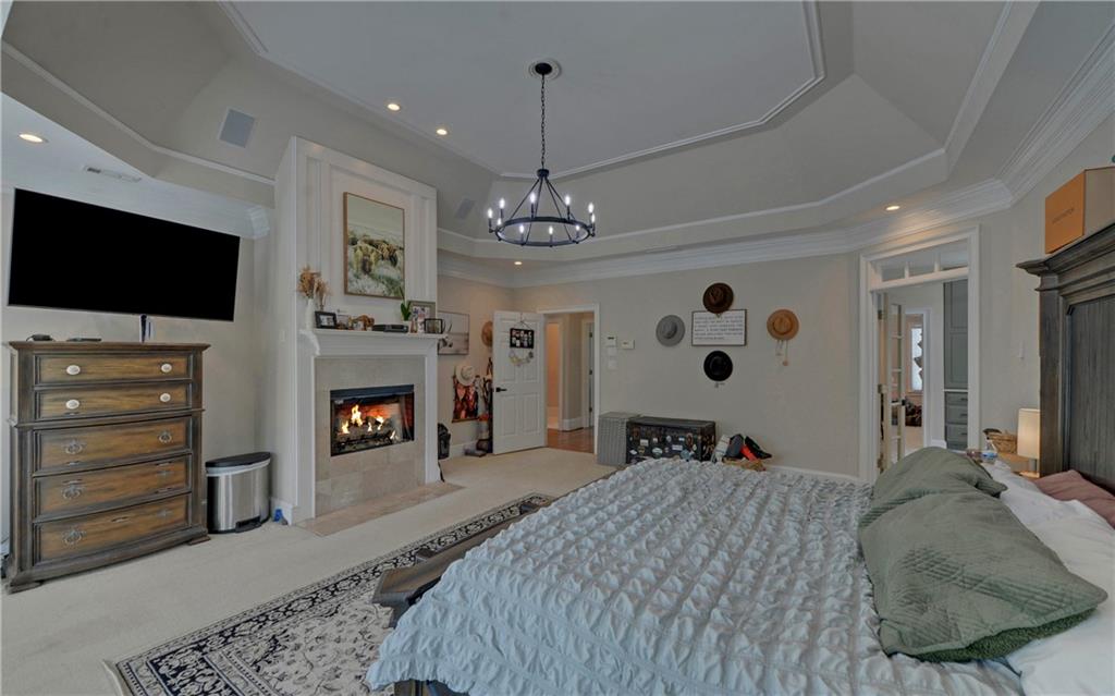 2760 Camp Branch Road Buford, GA 30519 - Photo 30 of 73 a spacious bedroom with a bed and a flat screen tv