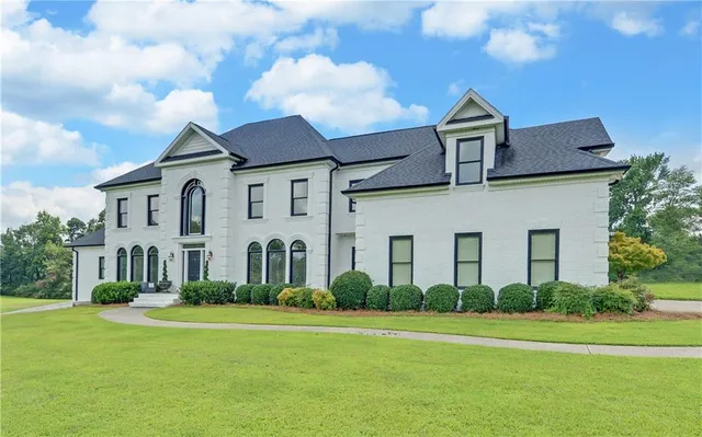 a front view of a house with a garden
