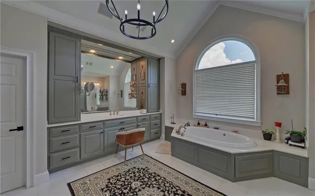 a bathroom with a granite countertop toilet sink and mirror