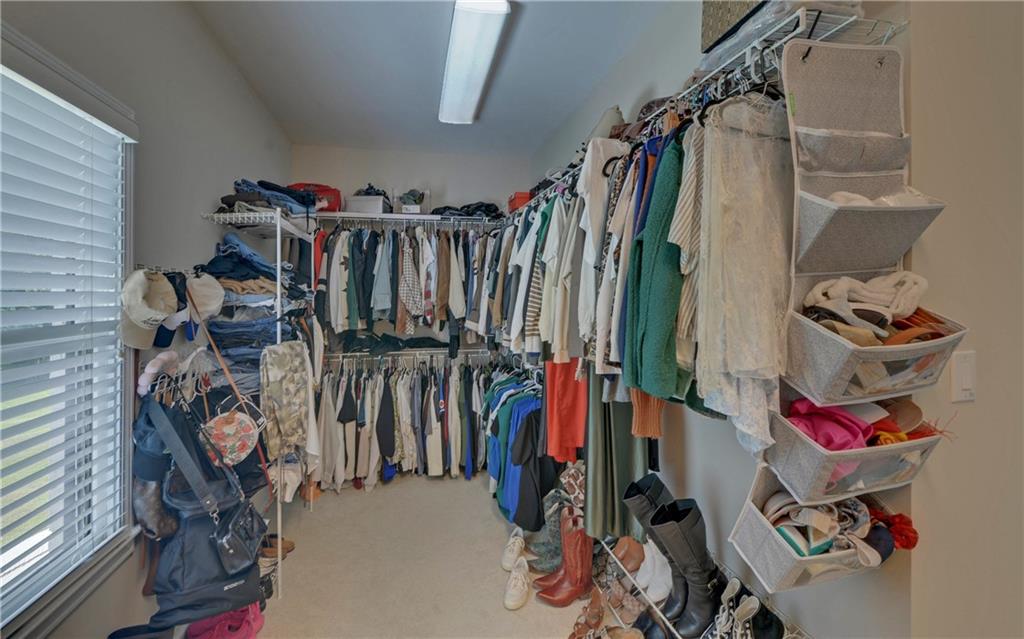 2760 Camp Branch Road Buford, GA 30519 - Photo 36 of 73 a view of walk in closet with clothes