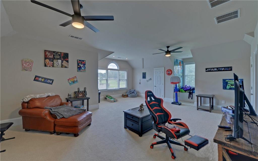 2760 Camp Branch Road Buford, GA 30519 - Photo 44 of 73 a living room with furniture a window and gym equipment