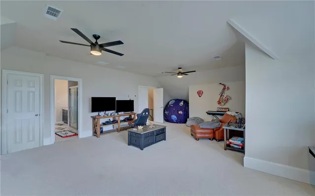 a view of a house with a big yard and potted plants