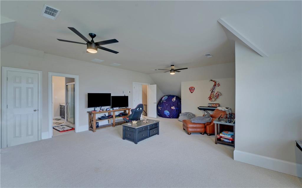 2760 Camp Branch Road Buford, GA 30519 - Photo 45 of 73 a living room with furniture and a flat screen tv
