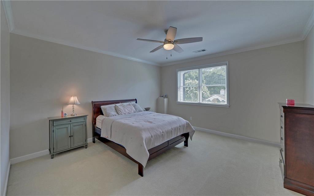 2760 Camp Branch Road Buford, GA 30519 - Photo 46 of 73 a spacious bedroom with a bed and a window